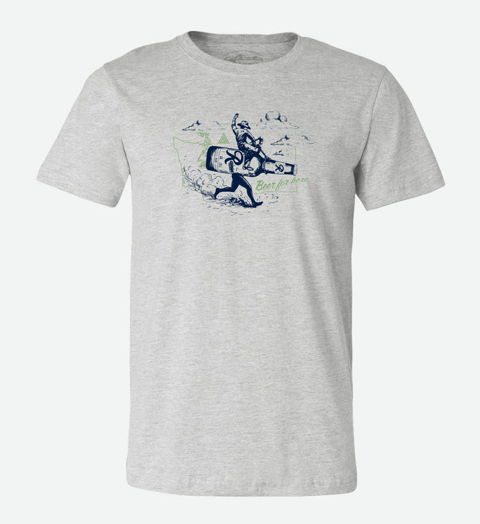 Heather grey t-shirt by The Great PNW featuring a vintage navy blue graphic of a cowboy riding a giant running Rainier Beer bottle. The design includes a light green outline of Washington state in the background and the text "Beer for here." written in green cursive.
