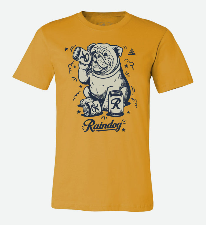 Mustard yellow t-shirt by The Great PNW featuring a graphic illustration of a bulldog drinking a can of Rainier Beer with the word "Raindog" written in cursive below.